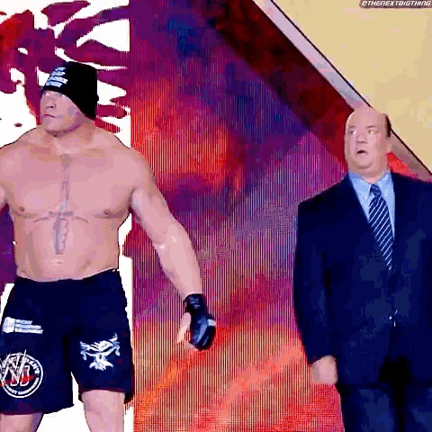 a man in a suit and tie is standing next to a man in a boxing outfit