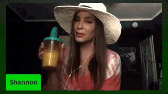 a woman wearing a straw hat is holding a drink and the name shannon is on the green screen
