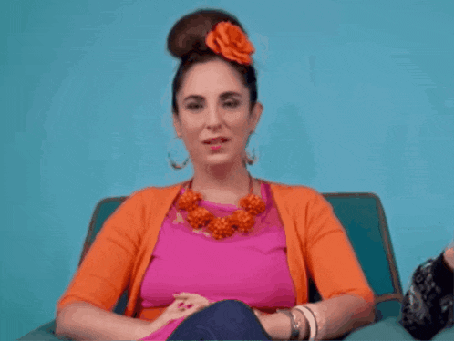 a woman with a flower in her hair is wearing a pink shirt with the word stu on it
