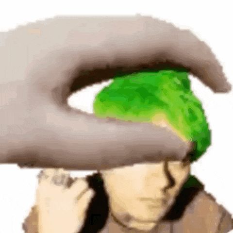 a hand is touching a person 's head with a green hair .