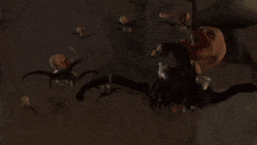 a robot with two heads is holding a gun and shooting fire
