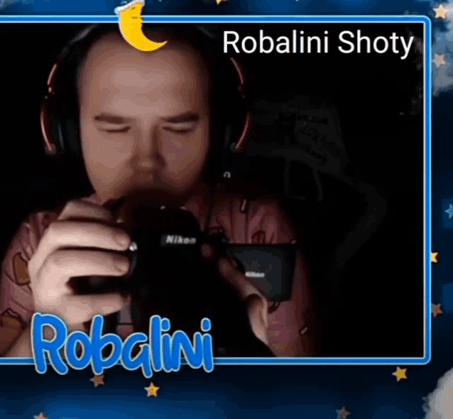 a man wearing headphones is holding a camera and the name robalini is on the bottom right