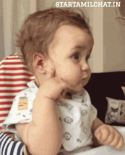 a baby is sitting in a high chair and the website starttamilchat.in is visible in the corner