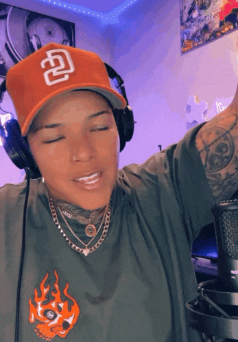 a person wearing headphones and a hat with a letter d on it