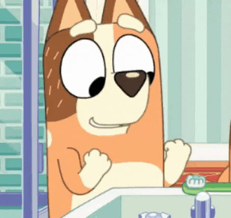 a cartoon dog is standing in front of a bathroom sink .