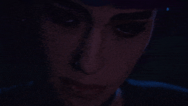 a close up of a woman 's face with blue eyes