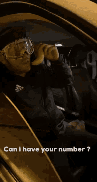 a man wearing goggles is holding a banana in his hand while driving a car