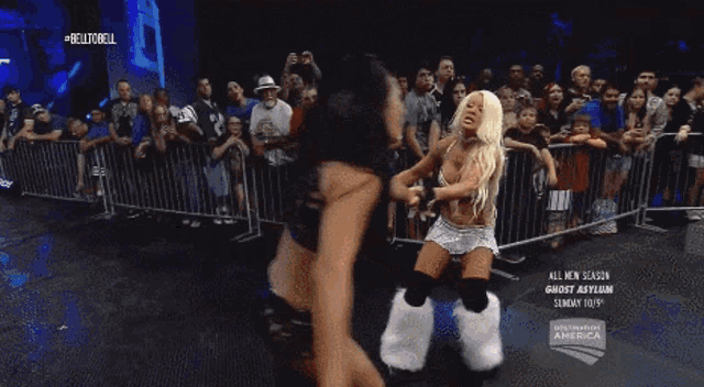 two female wrestlers are fighting in front of a crowd on sunday october 19th