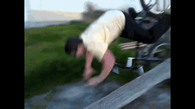 a man is doing a trick on a bicycle
