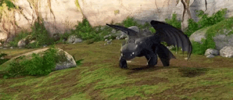 toothless from how to train your dragon is standing on top of a grassy hill .