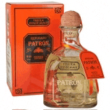a bottle of patron tequila next to a red box