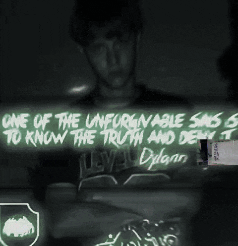 a man is standing in front of a sign that says one of the unforgivable sins is to know the truth and deliver it
