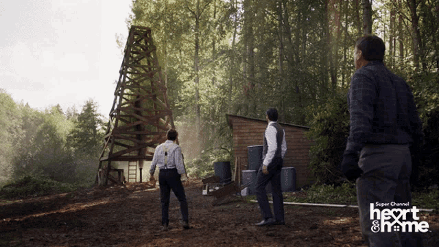 two men standing in a field with the words super channel heart & home