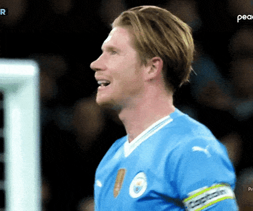 a soccer player in a blue jersey with the word peace on the bottom right
