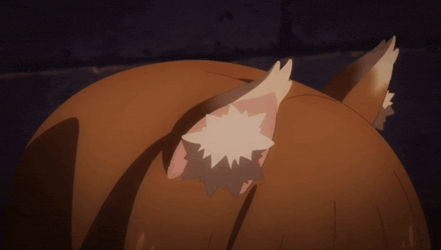 a close up of a fox 's ears with a white spot on them