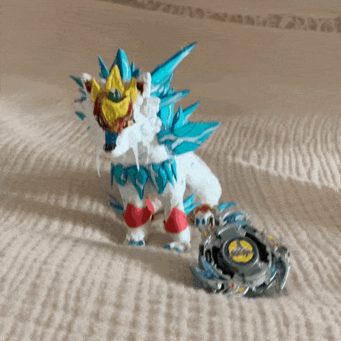 a statue of a lion with blue spikes is sitting next to a toy spinning top