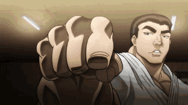 a man in a white karate uniform is pointing his finger at the camera
