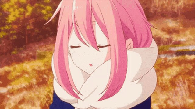 a girl with pink hair and a scarf around her neck is standing in the woods .