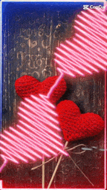 a picture of two crocheted hearts on sticks with the word love on the bottom right