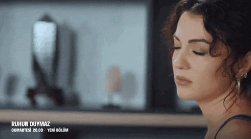 a close up of a woman 's face with ruhun duymaz written on the bottom