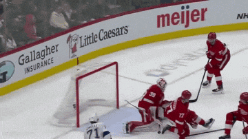 a hockey game is being played in front of a meijer sign
