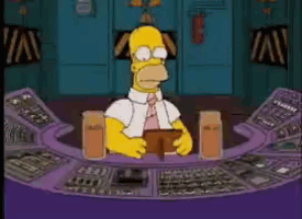 homer simpson is sitting at a desk with a wallet