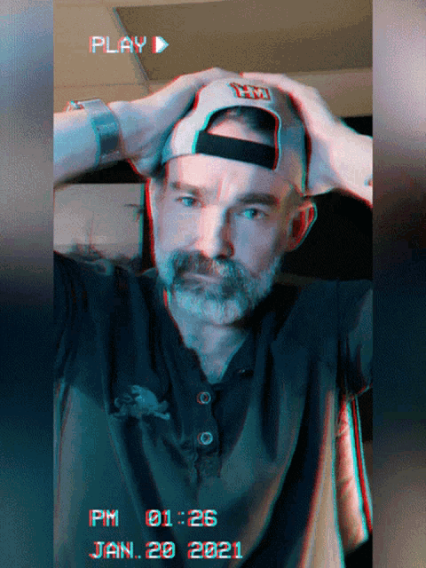 a man wearing a hat with the letter h on it