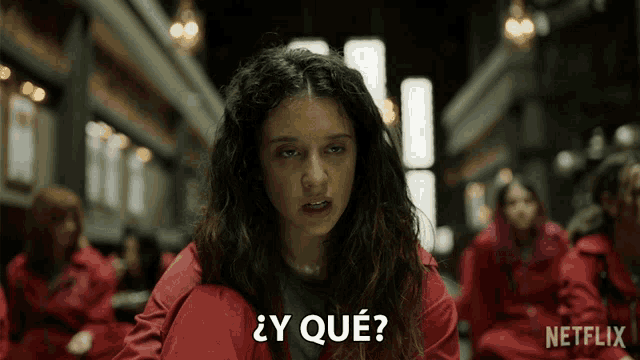 a woman in a red jacket says " y que " in front of a netflix logo