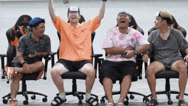 a group of men are sitting in chairs and one of them has a name tag that says ' uiu ' on it