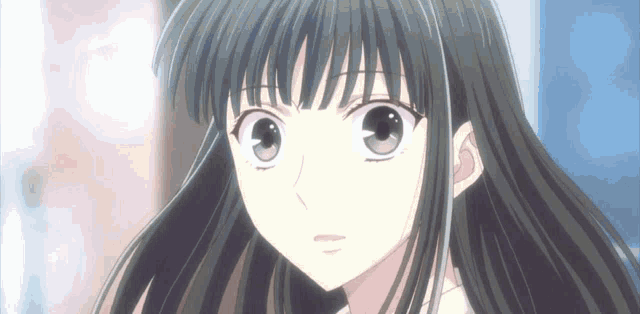 a close up of a girl with long black hair and a fringe looking at the camera .