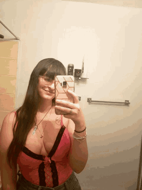 a woman taking a selfie in a bathroom with axe deodorant behind her