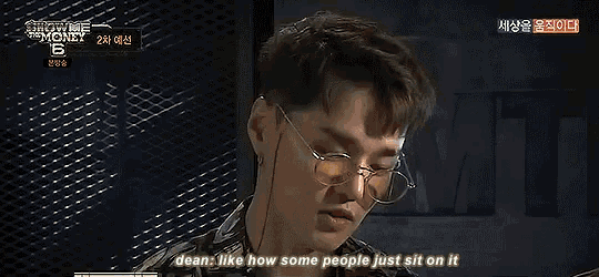 a man with glasses is talking about how some people sit on it