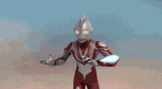 a cartoon character in a red and white suit is holding a glowing object