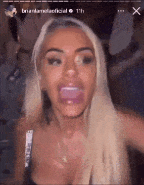 a woman with blonde hair is making a funny face