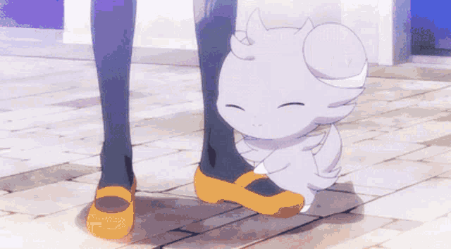 a person standing next to a small white cartoon character