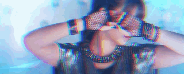 a woman wearing gloves and a necklace is covering her eyes .