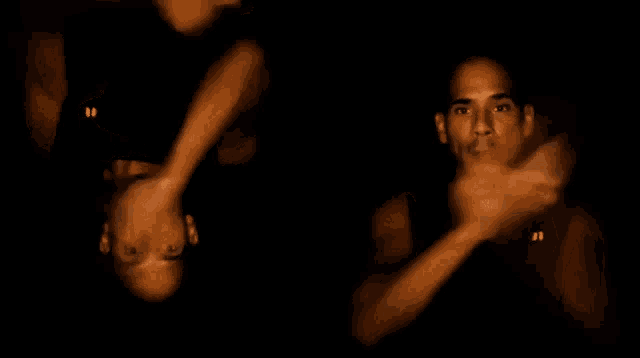 a blurry picture of a person 's face and hands with the letters u and i visible