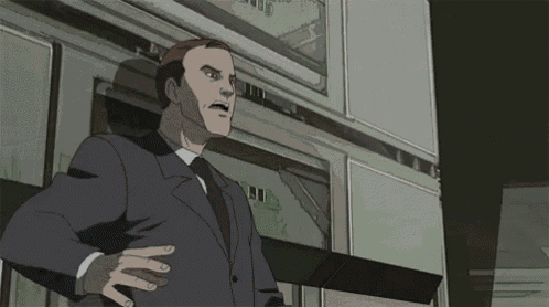 a man in a suit and tie is standing in front of a building with a sign that says stop