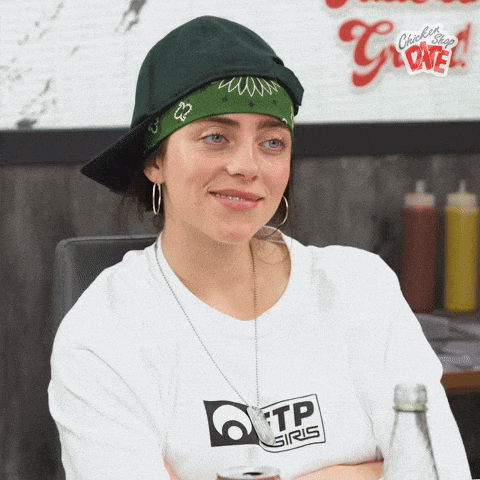 a woman wearing a bandana and a tp gris shirt
