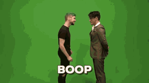 two men are standing next to each other on a green screen and talking .
