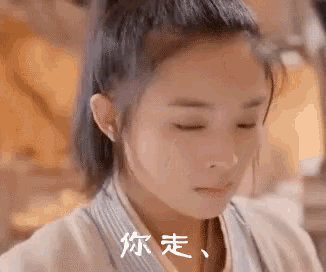 a close up of a woman 's face with her eyes closed and chinese writing on her face .