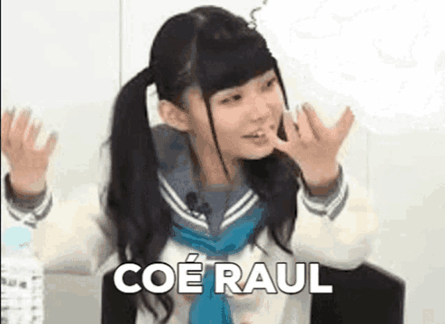 a girl in a school uniform is making a funny face while sitting in a chair with her hands in the air .