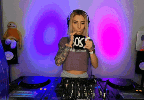 a woman wearing headphones holds a cup that says los angeles on it
