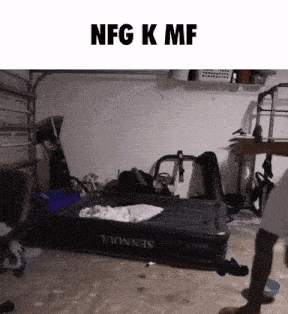 an inflatable bed in a garage with the words nfg k mf on the bottom