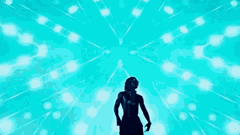 a man without a shirt is standing in front of a blue light display .