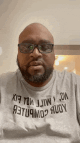a bald man with glasses and a beard is wearing a t-shirt that says a3tu9mo