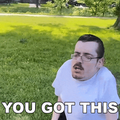 a man with glasses and a mustache is sitting in the grass with the words you got this above him