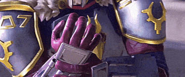 a close up of a person wearing armor and gloves with the number 07 on it