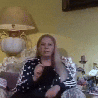 a woman is sitting in a chair with a lamp behind her