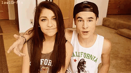 a boy and a girl are posing for a picture and the boy is wearing a california shirt